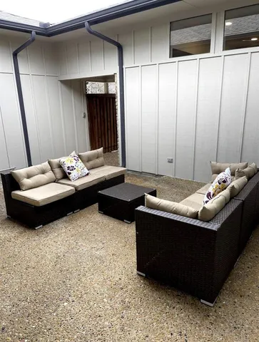 a view of backyard with brick wall