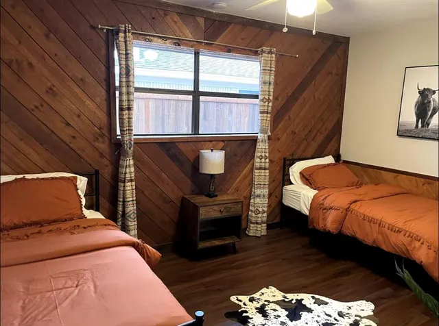 a bedroom with bed and wooden floor