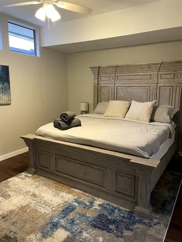 a bedroom with a bed and a dresser