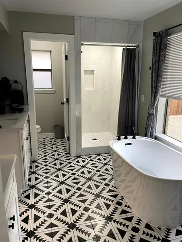 a bathroom with a bathtub and a shower