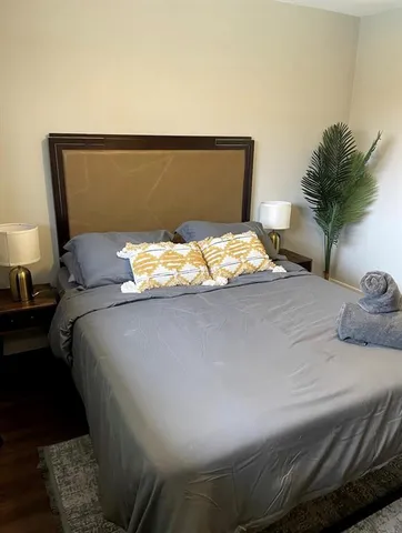 a bedroom with a bed and a potted plant