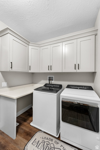 3678 Spiral Springs Road, Unit 204 Tooele, UT 84074 - Photo 24 of 59 Laundry area featuring wood-finish flooring, white cabinetry, integrated countertop, and matte black hardware