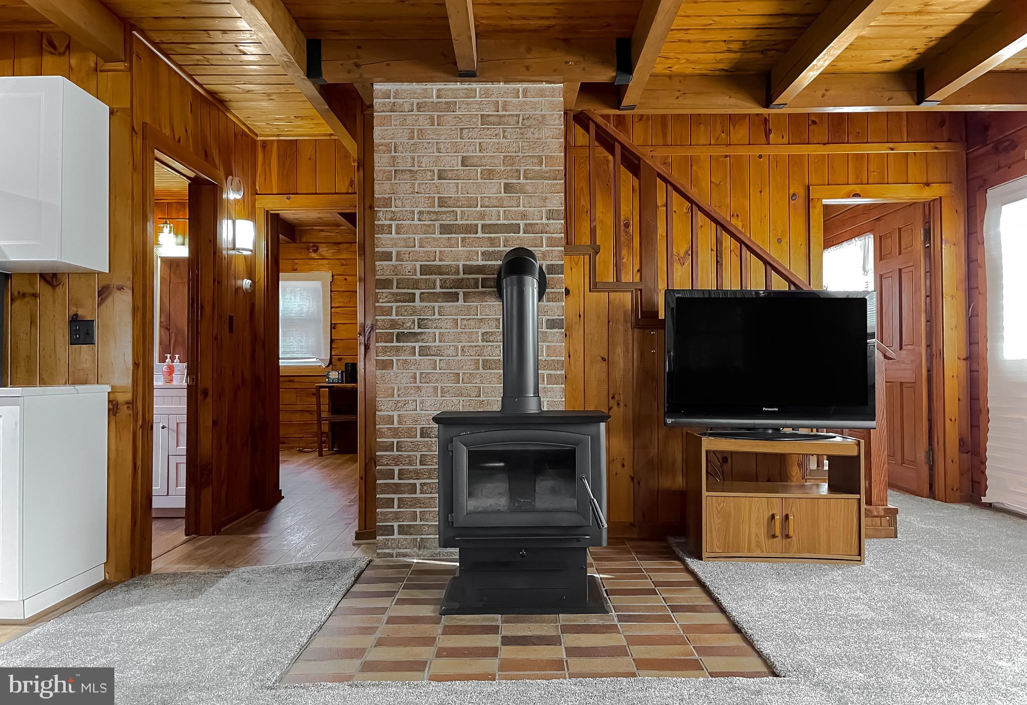23581 Belmar Drive Leonardtown, MD 20650 - Photo 20 of 54 a living room with fireplace furniture and a flat screen tv