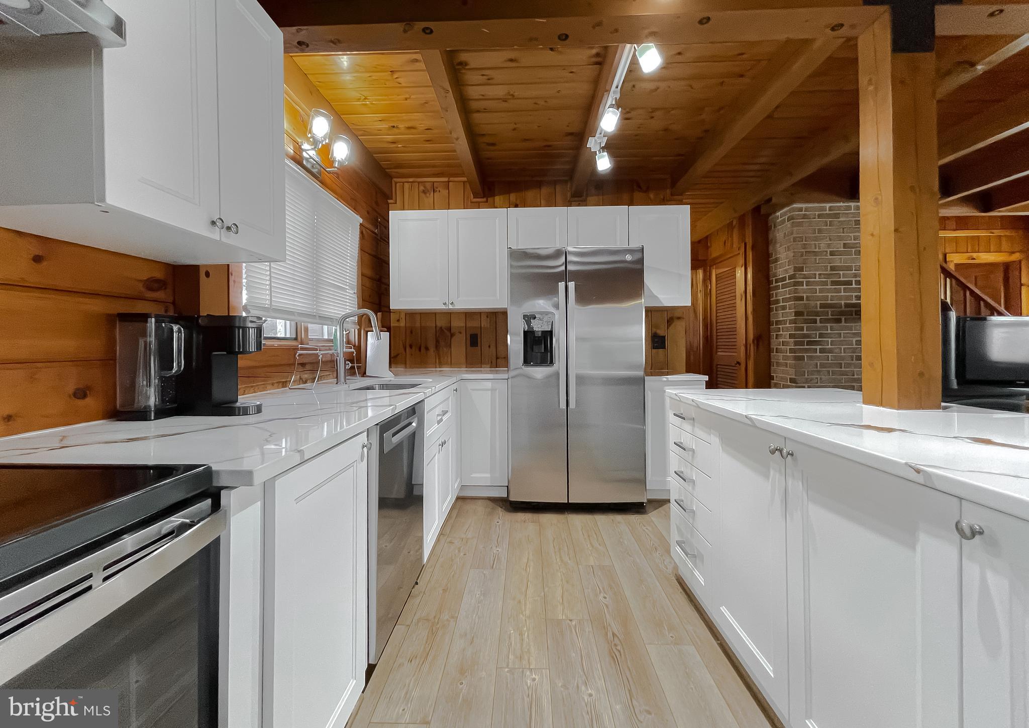 23581 Belmar Drive Leonardtown, MD 20650 - Photo 3 of 54 a kitchen with stainless steel appliances a sink a stove top oven a counter space and cabinets
