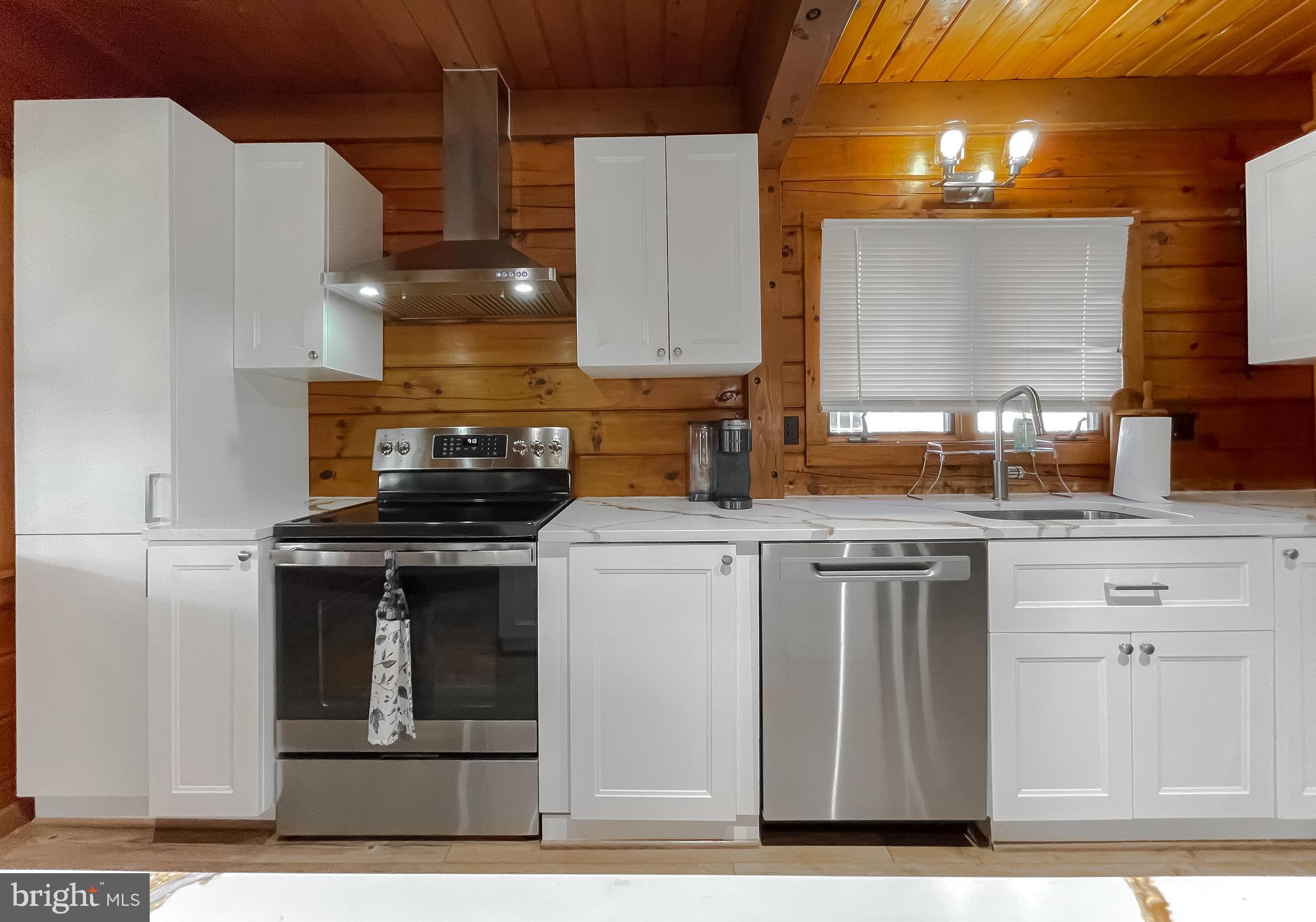 23581 Belmar Drive Leonardtown, MD 20650 - Photo 5 of 54 a kitchen with a stove and a white refrigerator