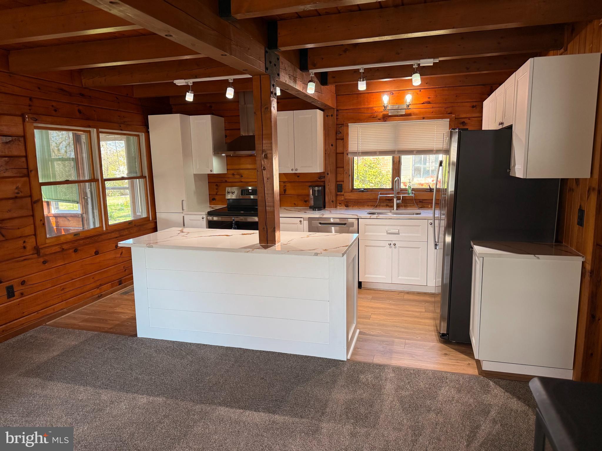 23581 Belmar Drive Leonardtown, MD 20650 - Photo 9 of 54 a living room with stainless steel appliances kitchen island granite countertop furniture and a fireplace