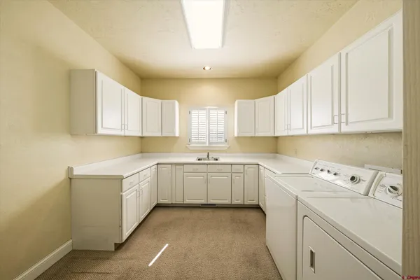 a bathroom with a granite countertop sink toilet a large mirror a bathtub and shower