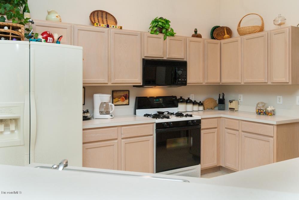 4313 Long Lake Road Melbourne, FL 32934 - Photo 15 of 26 OPEN KITCHEN WITH BREAKFAST BAR