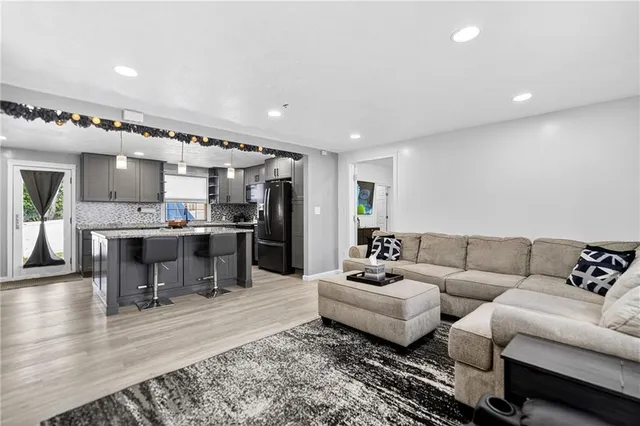 a living room with furniture and kitchen view