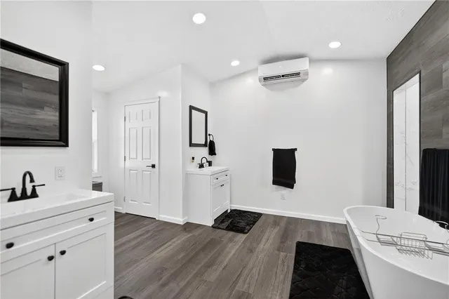 a hallway with a flat screen tv and a couch