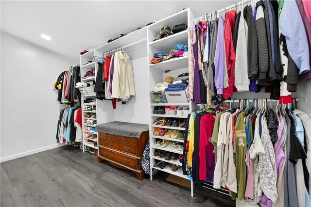 a view of walk in closet with clothes