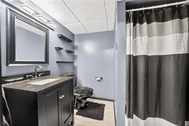 a bathroom with a sink a toilet and mirror