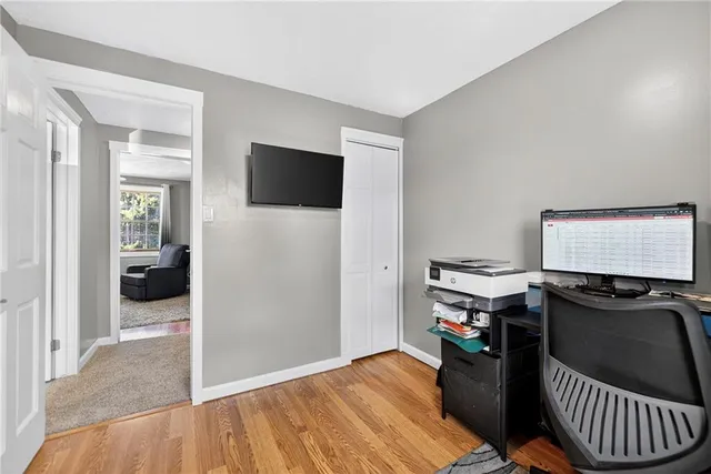 a view of a workspace with furniture and a bedroom
