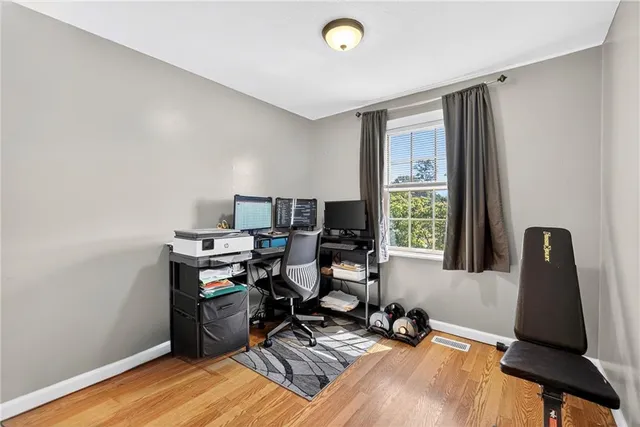 a view of a workspace with furniture and a window