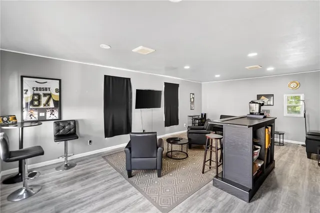 a living room with furniture a flat screen tv and a table