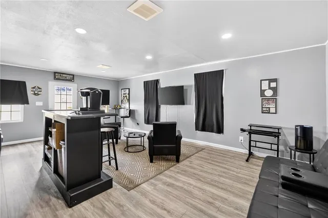 a living room with furniture a piano and a flat screen tv