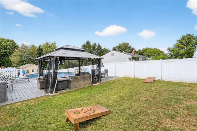 a view of a patio with table and chairs under an umbrella with wooden floor