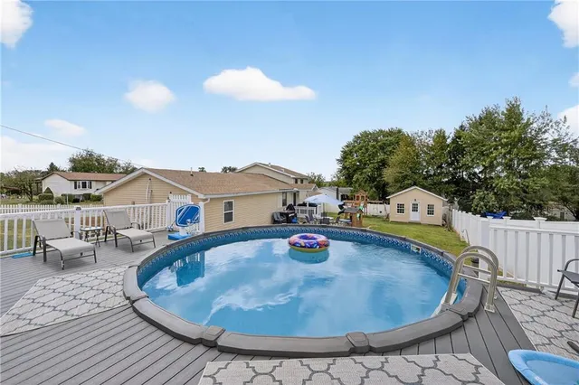 swimming pool view with a seating space