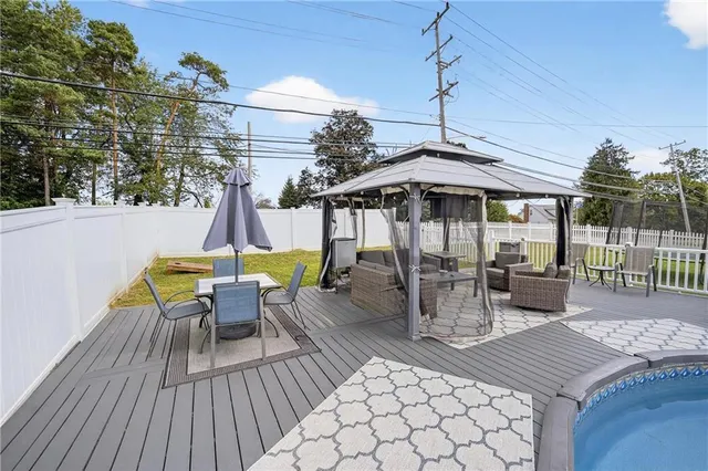 a view of a roof deck with table and chairs barbeque with wooden floor