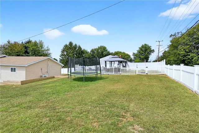 a swimming pool with outdoor seating and yard