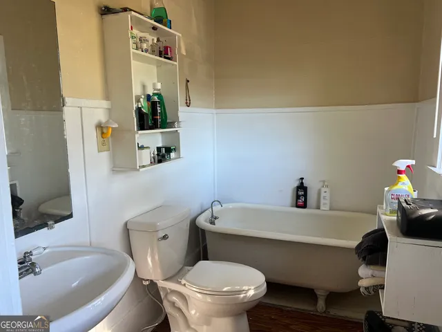 a white toilet sitting next to a bathroom sink