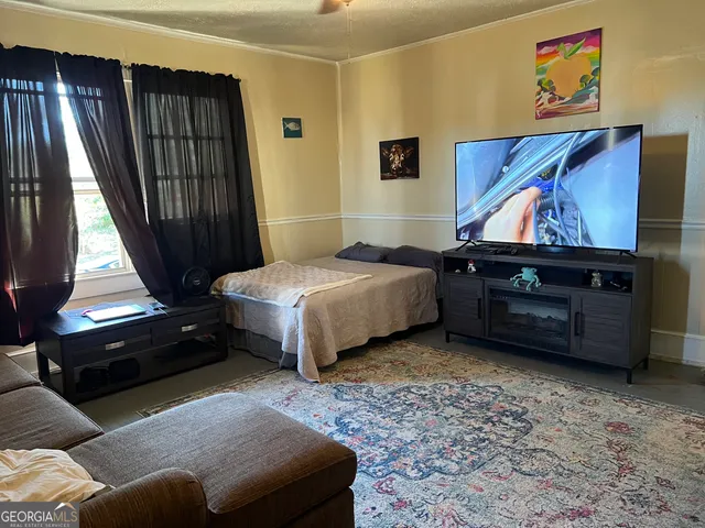 a bedroom with a bed closet and a window