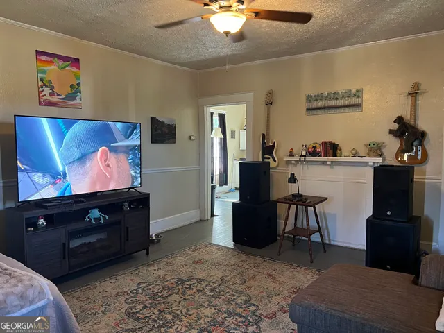 a living room with furniture and a flat screen tv