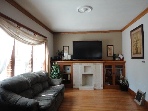 2529 Grove Avenue Berwyn, IL 60402 - Photo 2 of 16 a living room with fireplace furniture and a flat screen tv