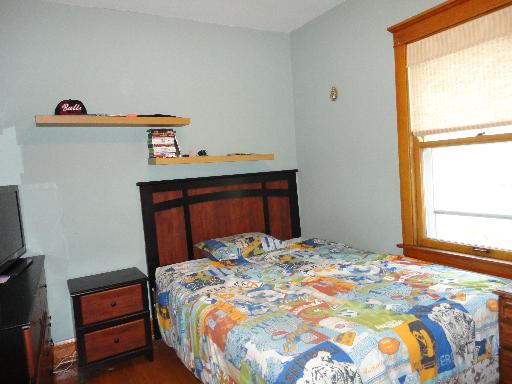 2529 Grove Avenue Berwyn, IL 60402 - Photo 11 of 16 a bedroom with a bed and a window