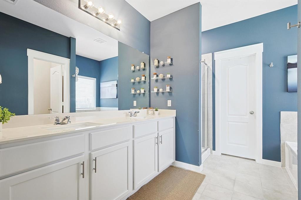 4235 Bullock Lane Forney, TX 75126 - Photo 22 of 40 a en suite bathroom with a double vanity sink and a mirror