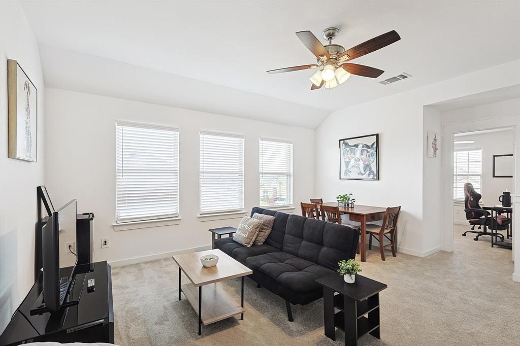 4235 Bullock Lane Forney, TX 75126 - Photo 26 of 40 a living room with furniture a window and a flat screen tv