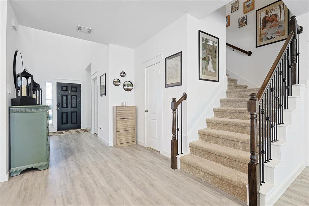4235 Bullock Lane Forney, TX 75126 - Photo 10 of 40 a view of a livingroom with wooden floor and stairs