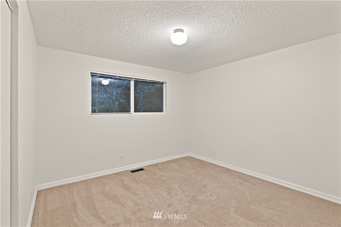 19728 45th Avenue Southeast Bothell, WA 98012 - Photo 14 of 25 an empty room with a empty space and window