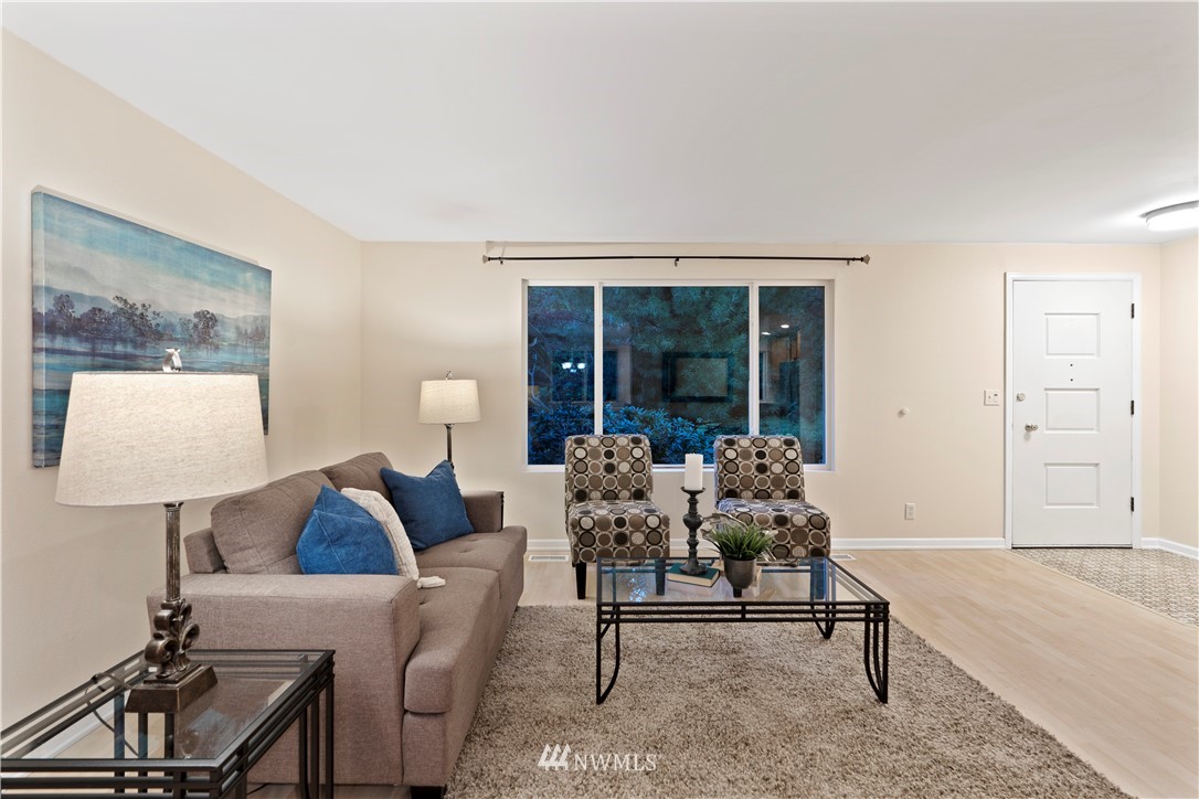 19728 45th Avenue Southeast Bothell, WA 98012 - Photo 6 of 25 a living room with furniture and a potted plant on table