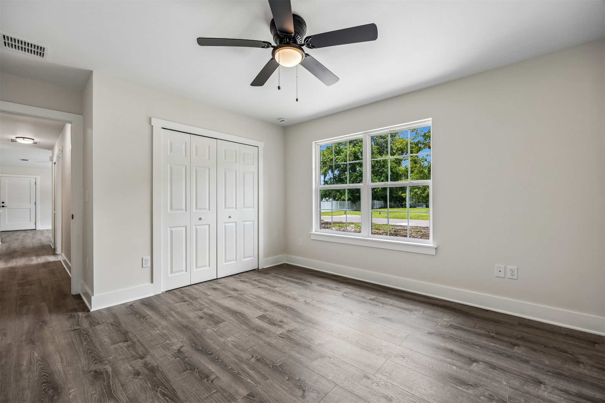 552 Sunset Road Fernandina Beach, FL 32034 - Photo 17 of 23 wooden floor in an empty room with a window