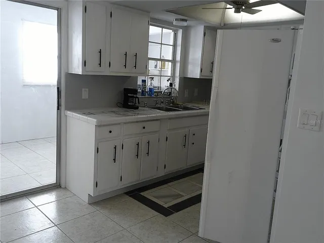 a kitchen with stainless steel appliances a sink stove and cabinets