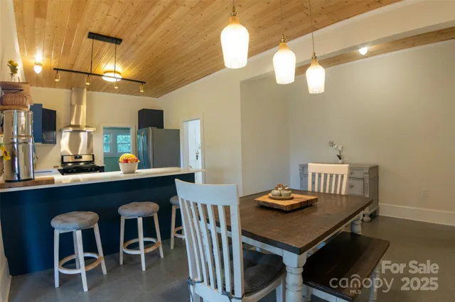 a view of a dining room with furniture and chandelier