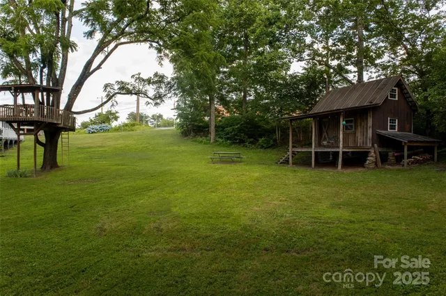 a view of an house with backyard space and balcony