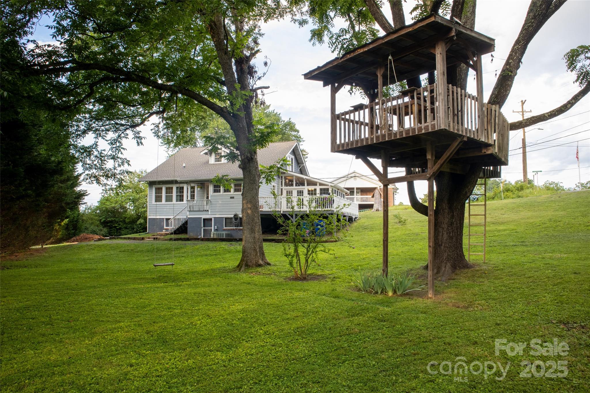 102 Cuthberson Street Morganton, NC 28655 - Photo 45 of 45 a view of a big yard with a table and chairs under an umbrella