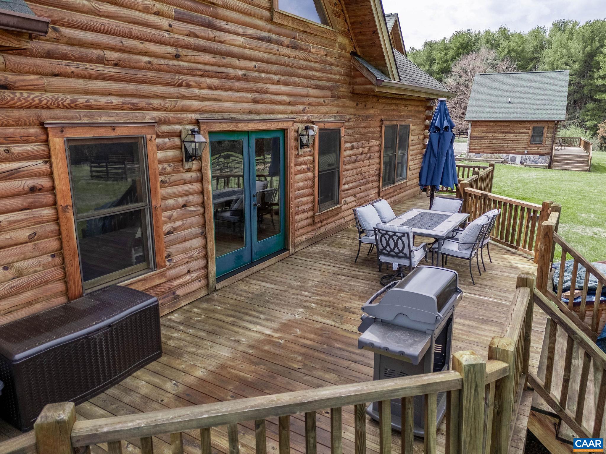 42 River Ridge Lane Stanardsville, VA 22973 - Photo 15 of 70 a view of a patio with table and chairs with wooden floor and fence