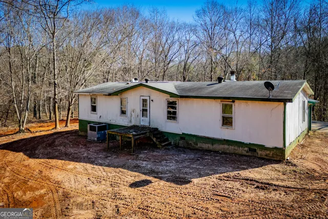 a backyard of a house with yard and outdoor seating