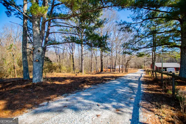 a view of backyard with wooden fence