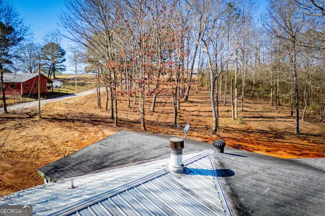 a view of a yard with wooden fence