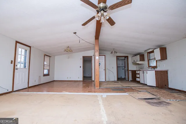 a view of a livingroom with a ceiling fan and window
