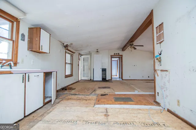 a view of a house with white walls and stairs