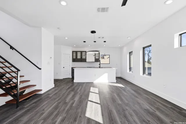 a view of kitchen and hall with wooden floor