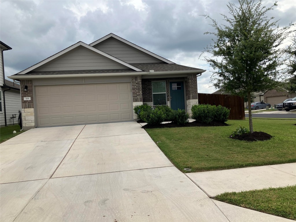 119 Mercer Street Bastrop, TX 78602 - Photo 1 of 19 a front view of a house with a yard and garage