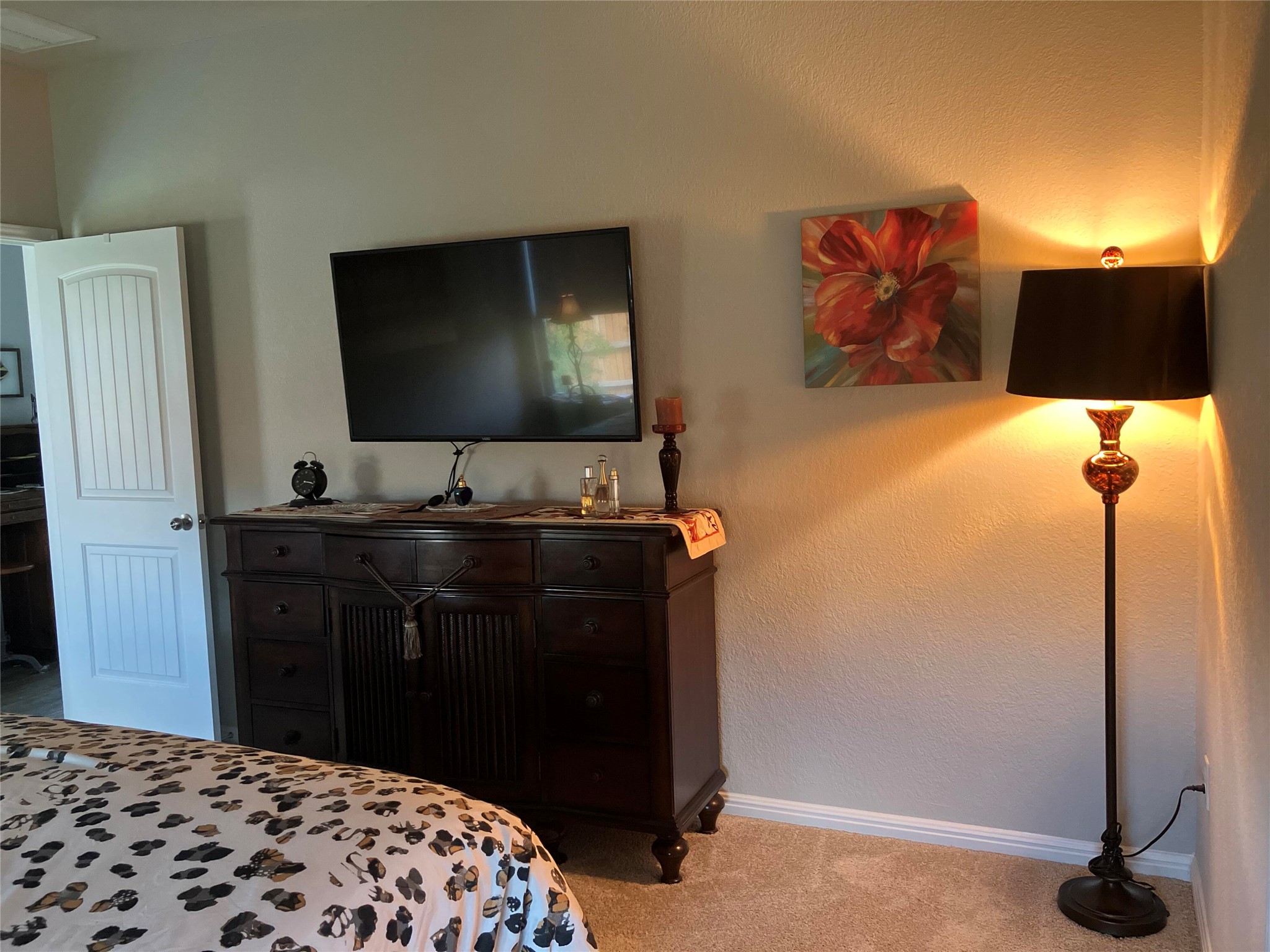 119 Mercer Street Bastrop, TX 78602 - Photo 11 of 19 Bedroom featuring light carpet and a textured wall