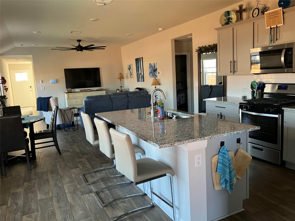 119 Mercer Street Bastrop, TX 78602 - Photo 19 of 19 a kitchen with stainless steel appliances granite countertop a sink and a refrigerator
