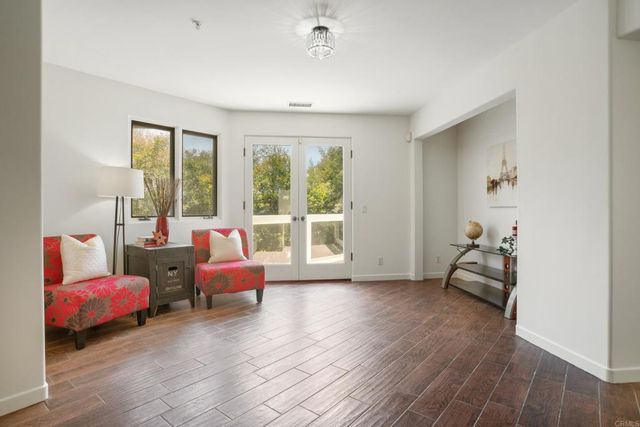 a bedroom with furniture and wooden floor